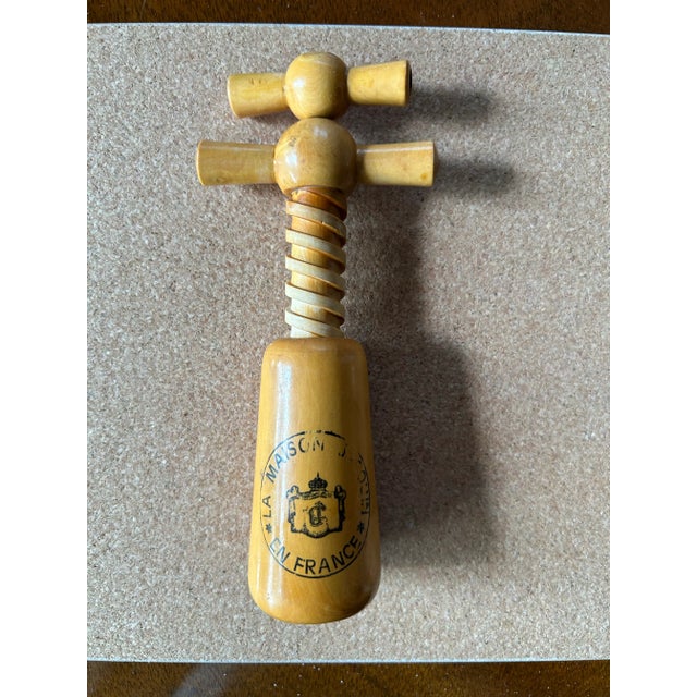 Mid century French wood wine opener. vintage with a double helix design. It features a stamp that reads "LA MAISON J. S....
