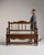 This piece presents as a bench with lift seat, distinguished by dark aged oak, carved crest, storage compartment....