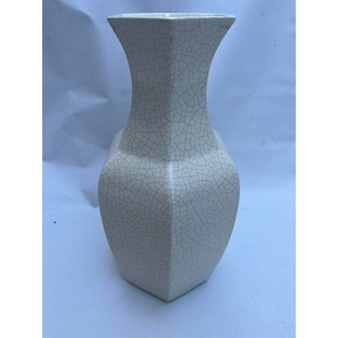 A single octagonal Chinese Song Dynasty style porcelain vase featuring a cream colored crackle finish.
