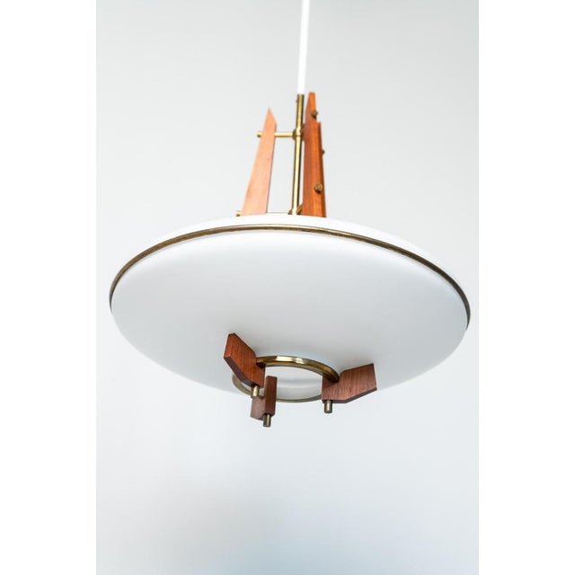 Teak, brass and opal glass pendant chandelier, Made in Italy, 1960s. Fantastic chandelier made in Italy in the 1960s. The...