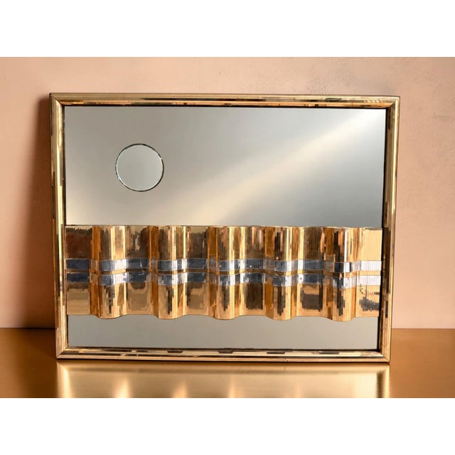 Beautiful vintage mixed-metal mirrored wall sculpture featuring a dimensional, wave-like design in polished gold and...