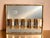Beautiful vintage mixed-metal mirrored wall sculpture featuring a dimensional, wave-like design in polished gold and...