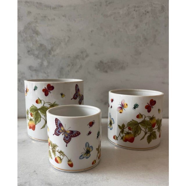 Set of 3 vintage 1970s Lentil Ardalt porcelain nesting canisters in the "Springtime Butterflies and Strawberries" pattern....
