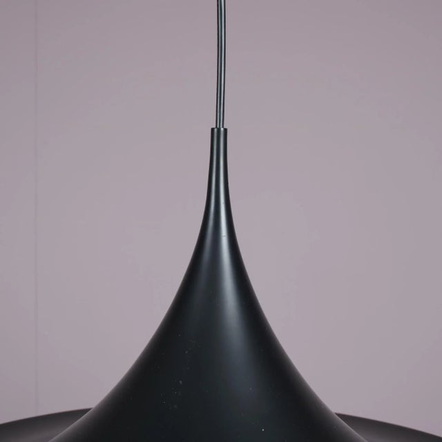 An eye-catching “Semi” hanging lamp, designed by Claus Bonderup & Torsten Thorup, manufactured by Fog & Morup in Denmark...