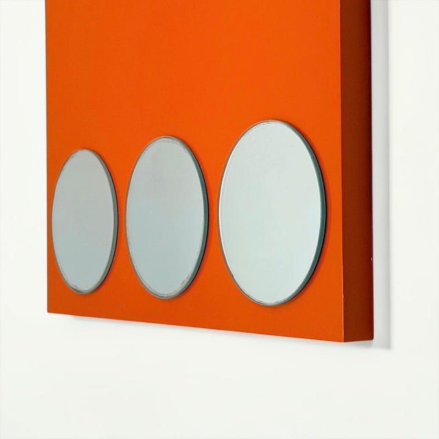 Geometric vintage wall mirror, likely dating from the 1980s, composed of three circular mirrors arranged vertically on a...