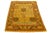 This beautiful vintage oushak hand-knotted wool rug has the goldenrod field and accents in brown, blue, and red in allover...