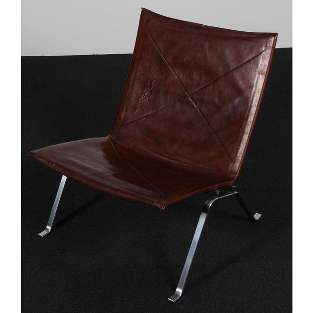 Poul Kjærholm lounge chair in original zigzag sewn heavily patinated nature leather. Frame of brushed steel. Model PK22,...