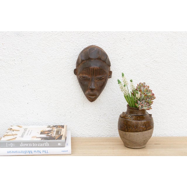 This exquisite Baule mask, originating from the Ivory Coast, is a testament to the refined artistry and cultural...