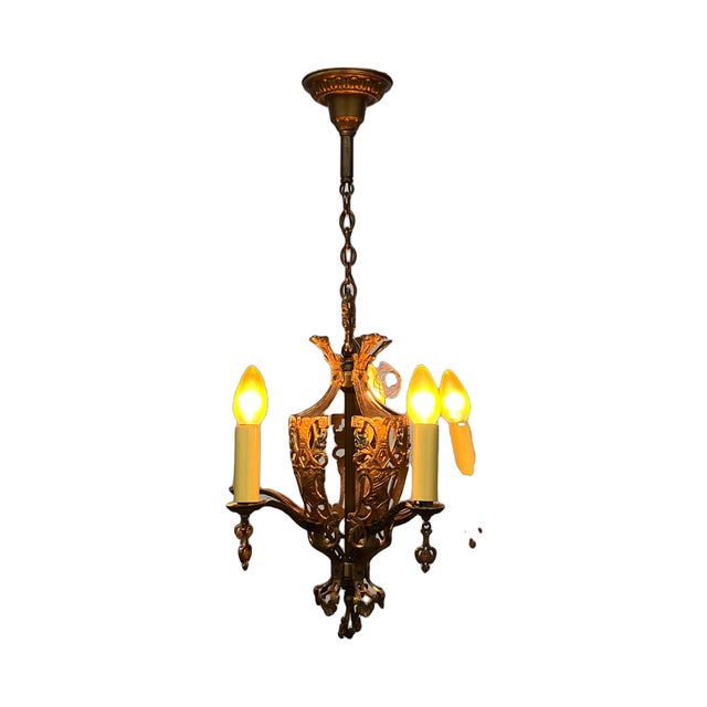 Lovely candle chandelier in cast bronze and original finish. All new electrical. Blue and orange accents on the bronze...