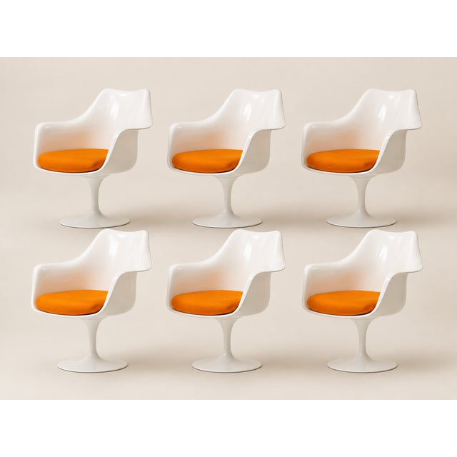 Six "Tulip" model armchairs in white lacquered cast aluminum and white fiberglass. with orange Knoll fabric cushions. Very...
