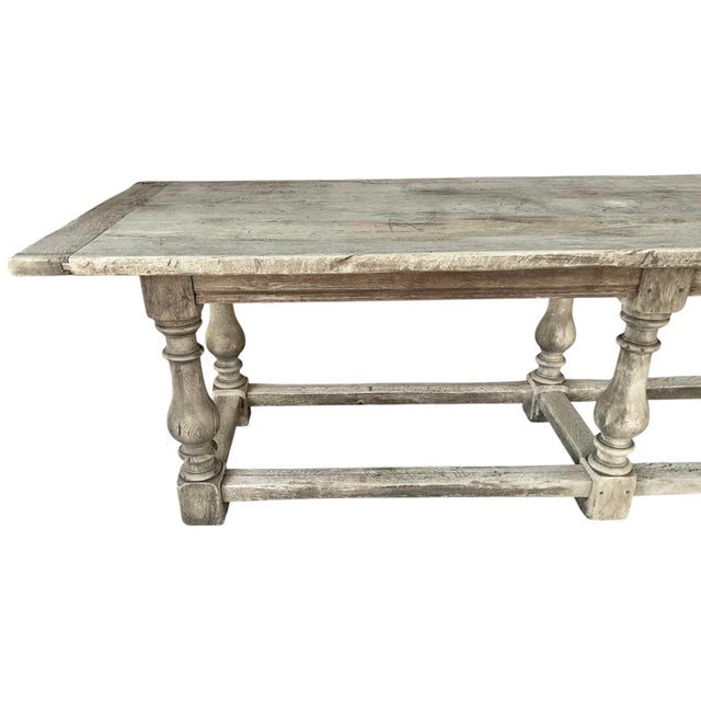 This Jacobean English Bleached Oak DIning Table is over nine feet in length. Table features a thick rectangular plank top...
