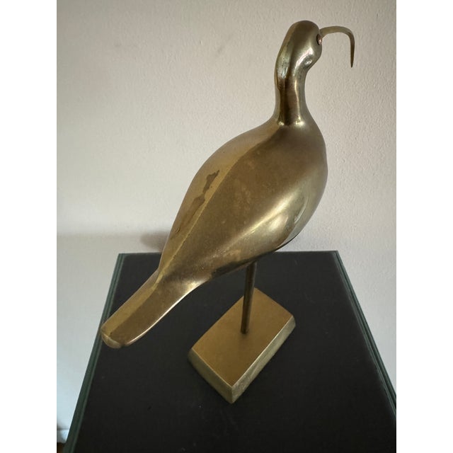 Unique vintage brass bird on a pedestal.