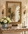 An elegant Neoclassical or Regency style giltwood mirror featuring a richly painted frame with scrolling acanthus details...
