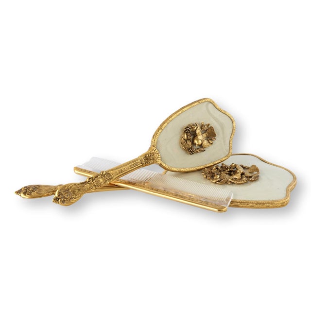 Mid 20th century vanity set featuring a large ornate filigree mirror with matching accessories including an unused brush...