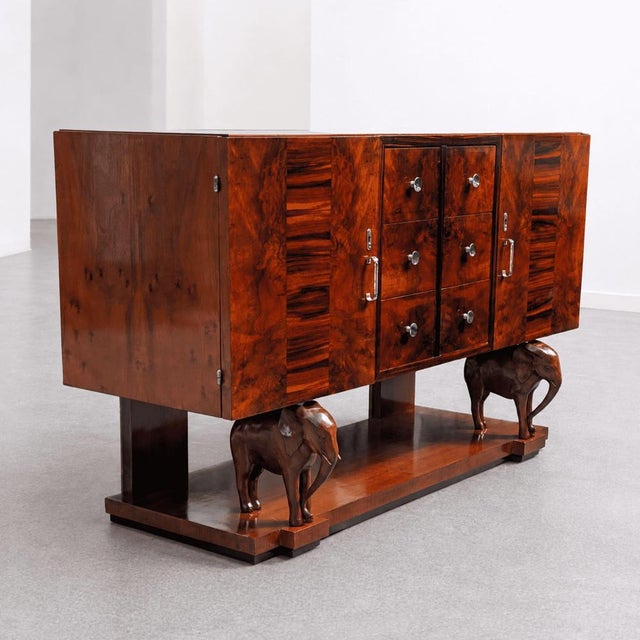 Extraordinary Sicilian Art Deco wooden sideboard with a glass top, central drawers, and side compartments. This piece...