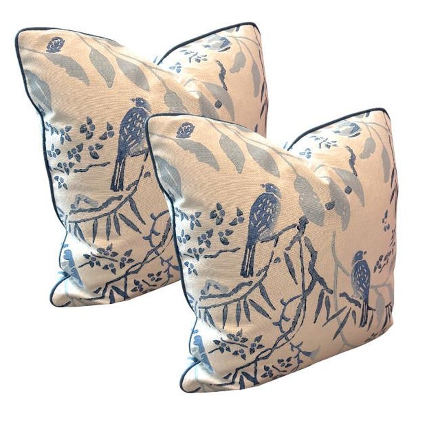 This elegant set of two throw pillows features a classic chinoiserie-inspired design, showcasing perched birds among...