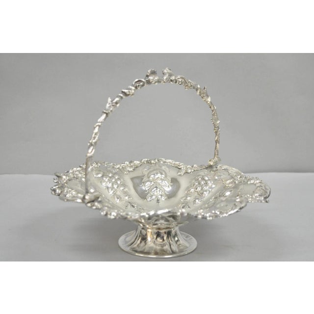 Antique Victorian Silver Plated Grapevine Repousse Dessert Basket Fruit Bowl with Ornate Handle. Circa Early 20th Century....