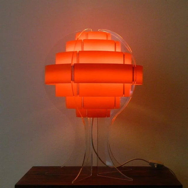 Vintage strips table lamp in round shape with orange stripes in a transparent acrylic glass body from Quality System...