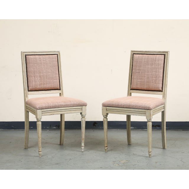 Pair of early 20th century French Louis XVI style painted side chairs. Original paint/distressed finish on frames with...