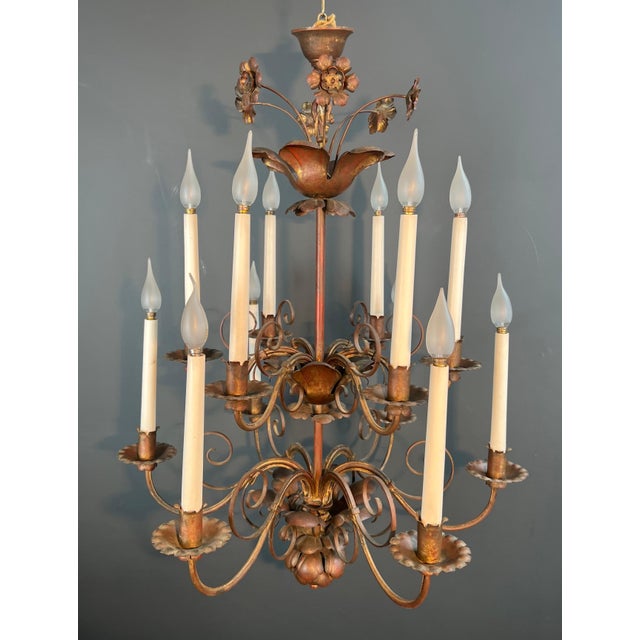 This magnificent 2-tier chandelier with 12 lights is made of gilded metal. It is a French work in the style of Maison...