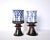 A pair of his and hers art pottery goblets or tall mugs with blue and white geometric designs on the cups and with brown...