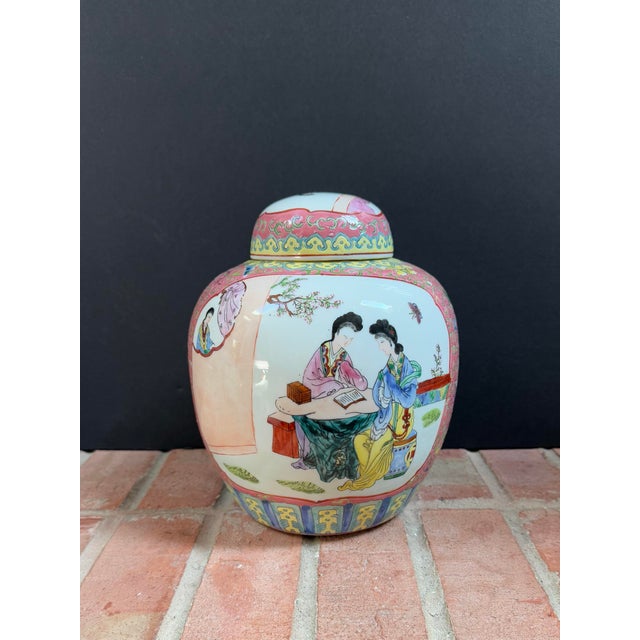 Large Chinese polychrome porcelain ginger jar with lid features hand painted figural garden scenes on the front and back....