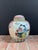 Large Chinese polychrome porcelain ginger jar with lid features hand painted figural garden scenes on the front and back....