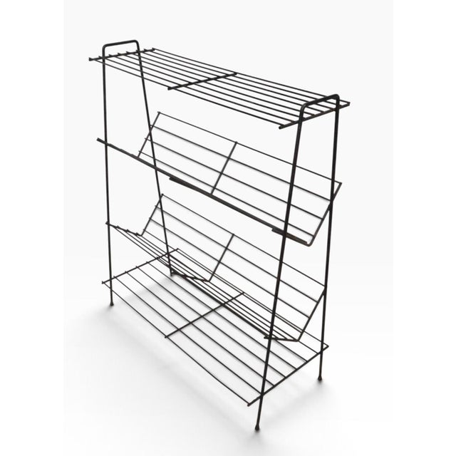Four tier mid century wire rod book shelf, in very good, original, clean and working condition. The stand features two...