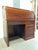 A handsome vintage roll-top desk crafted in the Asian Modern manner, featuring a beautifully figured mahogany-toned finish...