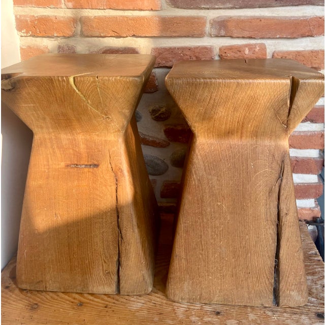 A striking pair of sculptural stools, hand-carved from solid oak blocks. Each piece showcases the raw beauty of the...