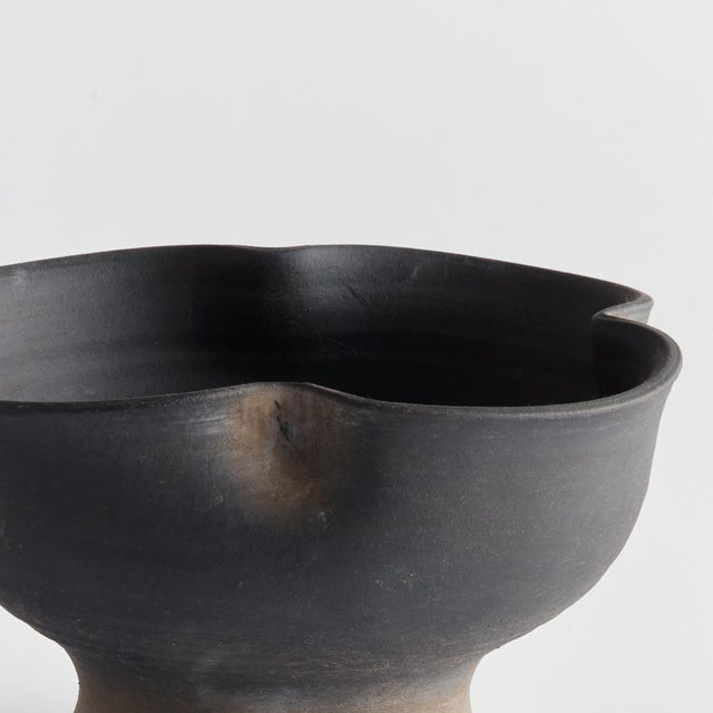 This footed bowl is hand thrown and formed by an artisan, s touch. But the real story is in the glaze. The dynamic texture...