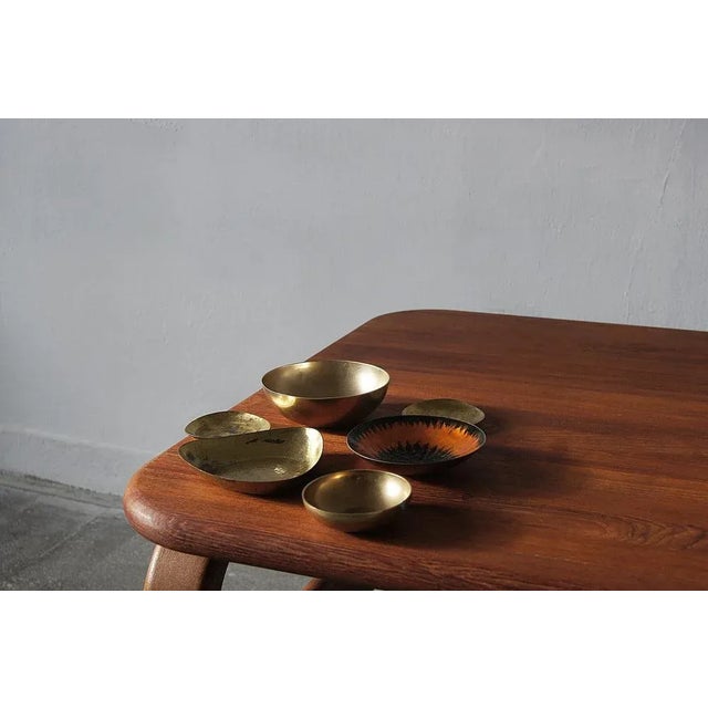 Platters made of brass - one of them covered with unevenly glossy enamel with an interesting texture resembling spilled...