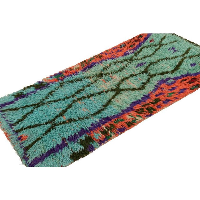 Hand-knotted in wool and originating from Morocco circa 1950-1960, this 3x6 vintage Moroccan rug is an extremely rare...