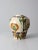 This art pottery vase reflects the Tang sancai style, featuring molded floral ornament beneath flowing polychrome glazes...