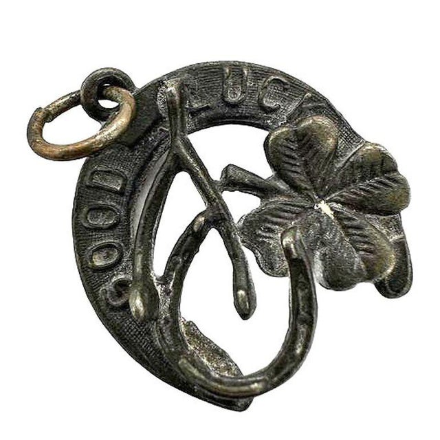 Original Pre-war sterling silver horseshoe pendant/lucky charm adorned with a four-leaf clover, wishbone, and the words...
