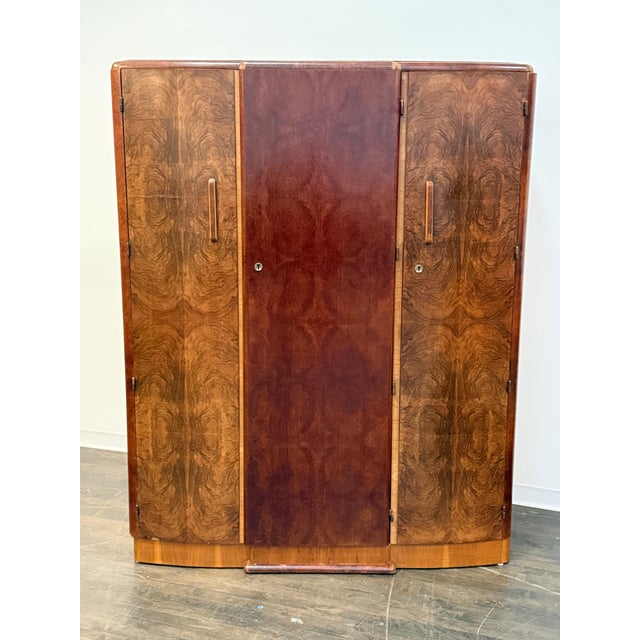 Design Plus Gallery presents an Art Deco Walnut Elm Door Wardrobe. The piece is so becoming with a modest silhouette that...