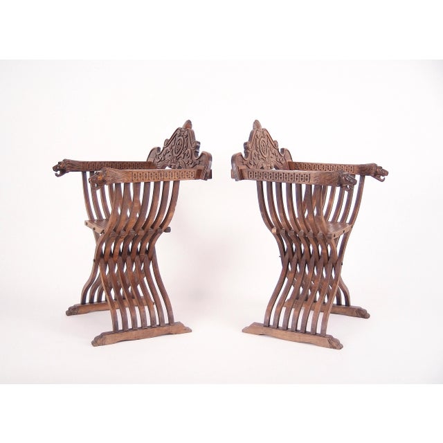 Scissor chair (also known as Savonarola Chair ) made of eight curved, intersecting slats forming the letter "X", connected...
