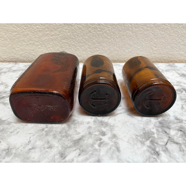 Vintage set of three brown apothecary bottles for decor and or storage. One rectangular and two round bottles.