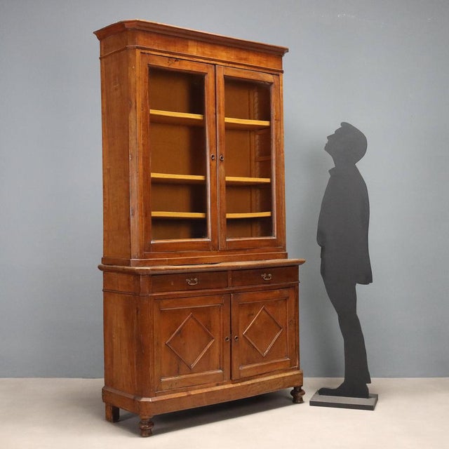 Walnut sideboard. Upper part with a pair of glass doors, three internal shelves adjustable in height via a rack. Base with...