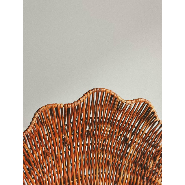 Inspired by the graceful form of a seashell, this hand woven wicker bowl is a wonderful example of the organic decorative...