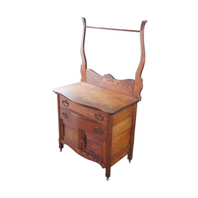 Antique Victorian wash stand or dry sink. Made of quartersawn oak featuring serpentine bowfront design with two drawers,...