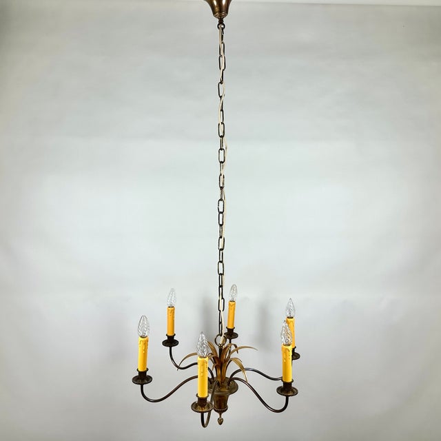 Bring a touch of iconic glamour into your home with this exquisite vintage palm chandelier from the renowned s.a....