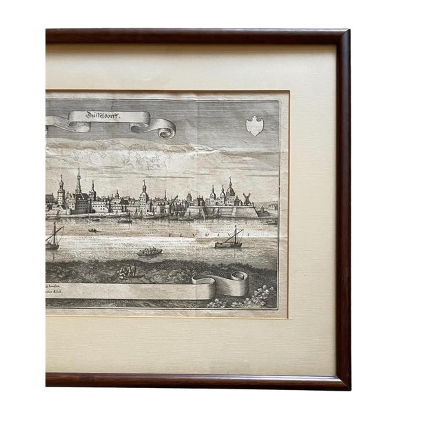 The piece is an antique engraving (1647) of the Rhine River in Düsseldorf by Matthäus Merian the Elder and was part of...