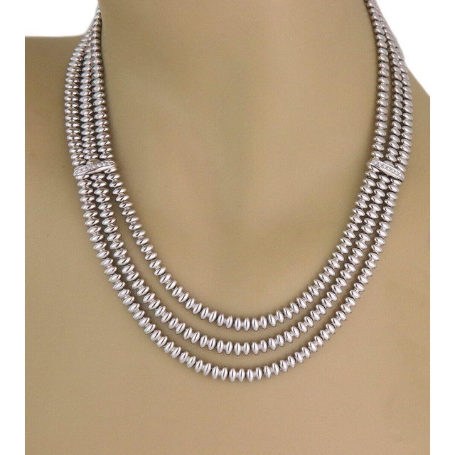 This is a stunning necklace by Chiampsean, it is crafted from 18k white gold featuring 3 rows with oval shape high...