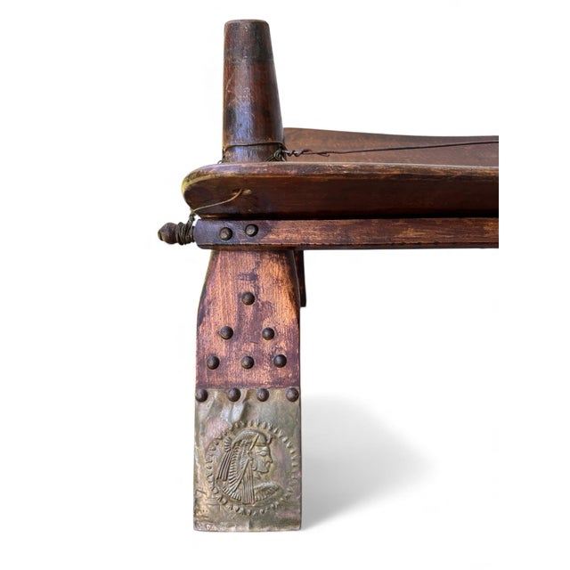 Bring authentic Middle Eastern history into your home with this antique Egyptian camel saddle stool, a beautifully...