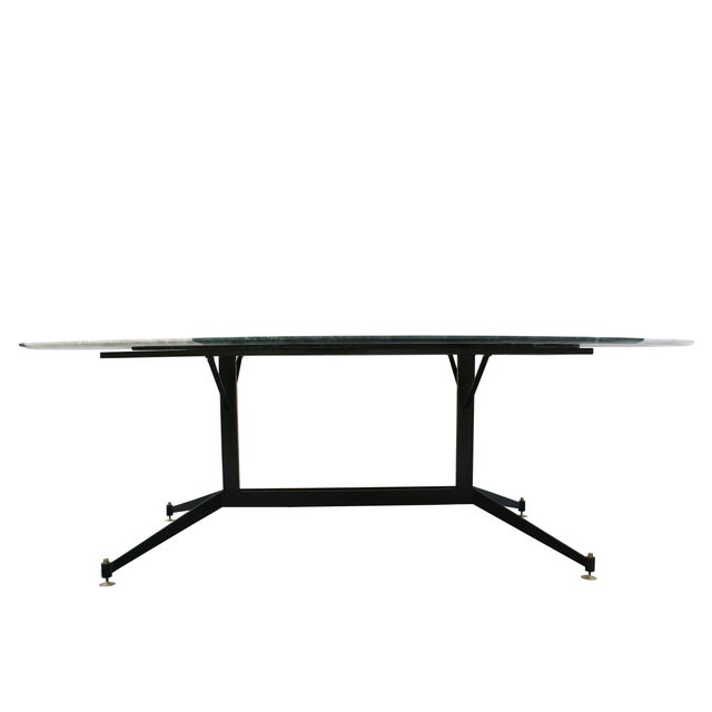 Dining table composed of a base of the 1950s made of metal lacquered in black with original italian feet finished in a...
