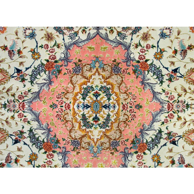 A remarkable late 20th century Persian Tabriz hand-knotted silk and wool rug with a mesmerizing pattern with a central...