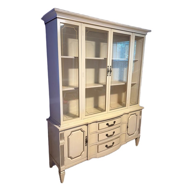 A striking, exceptionally well-crafted mid-century modern French Provincial style one-piece china cabinet and display...
