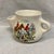 White ceramic mug depicting riders and hounds in a hunting scene. Designed to hold hot water in a lower chamber to keep...
