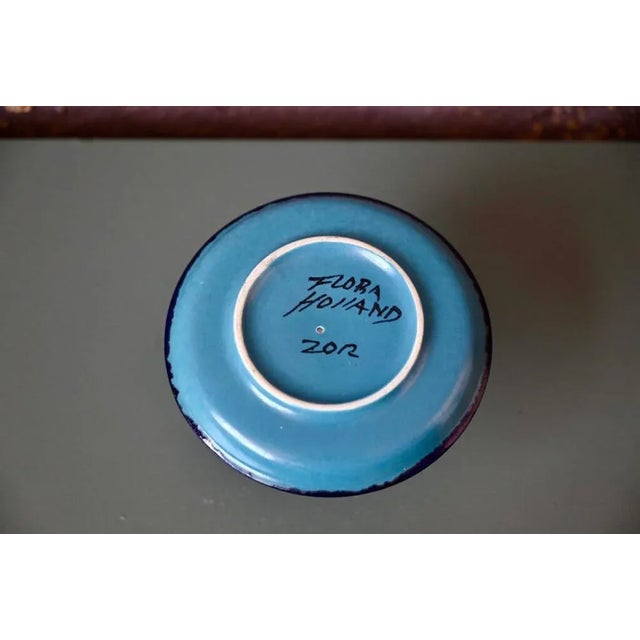 This pretty sandstone candle holder is a Dutch production signed Flora. It is nicely enamelled in blue and green tones....